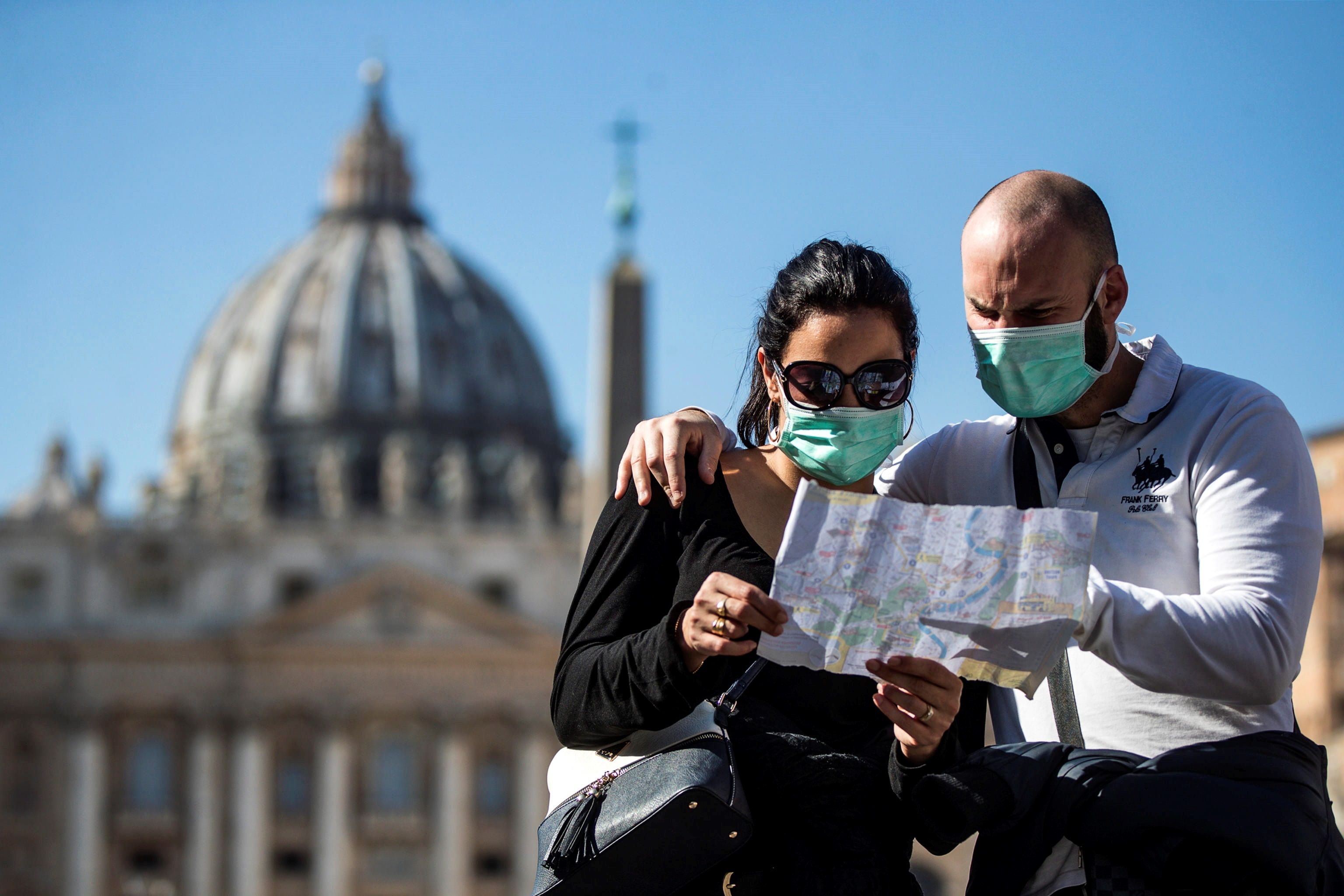 Una pareja de turistas con máscaras faciales sanitarias visita la Plaza de San Pedro. (Foto Prensa Libre: EFE)
