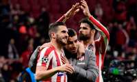 Atletico Madrid's Spanish midfielder Koke (L), Atletico Madrid's Argentine forward Angel Correa (C) and Atletico Madrid's Spanish forward Diego Costa celebrate their win at the end of the UEFA Champions League, round of 16, first leg football match between Club Atletico de Madrid and Liverpool FC at the Wanda Metropolitano stadium in Madrid on February 18, 2020. (Photo by JAVIER SORIANO / AFP)