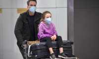 Passengers, wearing masks as a precautionary measure to avoid contracting the Covid-19 virus, travel through Guarulhos International Airport, in Guarulhos, Sao Paulo, Brazil on February 26, 2020. - The Brazilian Health Ministry confirmed Wednesday the diagnosis of coronavirus of a Brazilian resident in Sao Paulo, which became the first case of this epidemic in Latin America. The initial diagnosis "was confirmed," Minister Luiz Henrique Mandetta said at a press conference in Brasilia. (Photo by NELSON ALMEIDA / AFP)