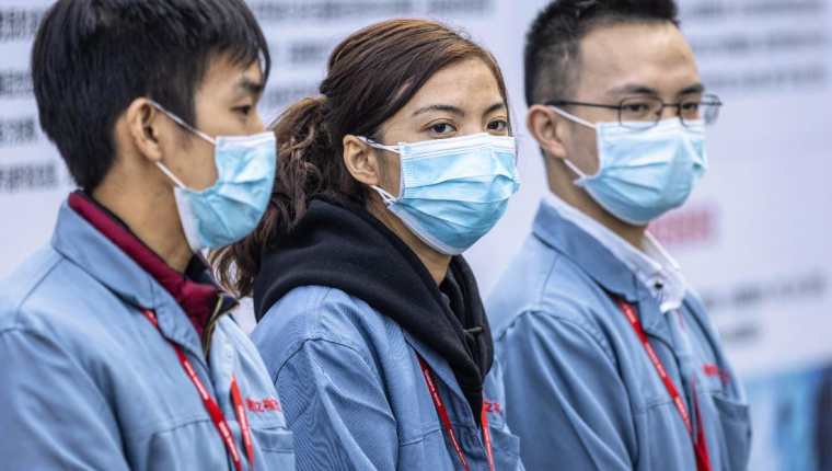 Ciudadanos chinos usan mascarillas para protegerse del coronavirus. (Foto Prensa Libre: EFE). 