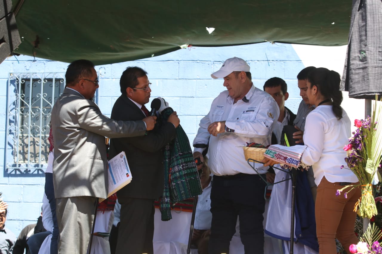 Óscar Chojolán, alcalde de Cantel, entrega una chumpa al presidente Alejandro Giammattei que visitó este municipio. (Foto Prensa Libre: Raúl Juárez) 