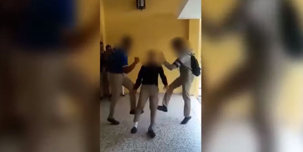 Imágenes en redes sociales muestran a tres alumnos que practican el reto, cuando el joven de en medio cae y le rebota la cabeza en el piso. (Foto Prensa Libre: Tomada de Youtube) 