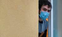 Jonathan Peterschmitt, a doctor infected with COVID-19, the new coronavirus, poses at the window of his medical office in Bernwiller, eastern France, on March 4, 2020. - Contaminated by the coronavirus after an evangelical gathering, Peterschmitt, who is confined in Bernwiller with his wife and four children, says he does not feel concerns for his family, of whom some are also affected, but notes that "the virus is always one step ahead".  Peterschmitt attended a week of fasting and prayer with an evangelical church in Mulhouse from February 17 to 24, which brought together some 2,000 faithfuls. The gathering has caused 10 contaminations in the department, according to the prefecture. (Photo by SEBASTIEN BOZON / AFP)
