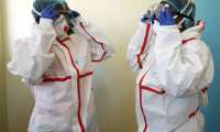 Kenyan health workers wear protective suits during a demonstration for preparations for any potential cases of the new coronavirus dubbed COVID-19, at the Mbgathi District hospital in Nairobi on March 6, 2020. (Photo by SIMON MAINA / AFP)