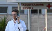 Italian doctor Massimo Fantoni speaks on his mobile phone outside the newly built Columbus Covid 2 temporary hospital to fight the new coronavirus infection, on March 16, 2020 at the Gemelli hospital in Rome. (Photo by ANDREAS SOLARO / AFP)