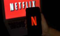 In this photo illustration a computer screen and mobile phone display the Netflix logo on March 31, 2020 in Arlington, Virginia. - According to Netflix chief content officer Ted Sarandos, Netflix viewership is on the rise during the coronavirus outbreak. (Photo by Olivier DOULIERY / AFP)