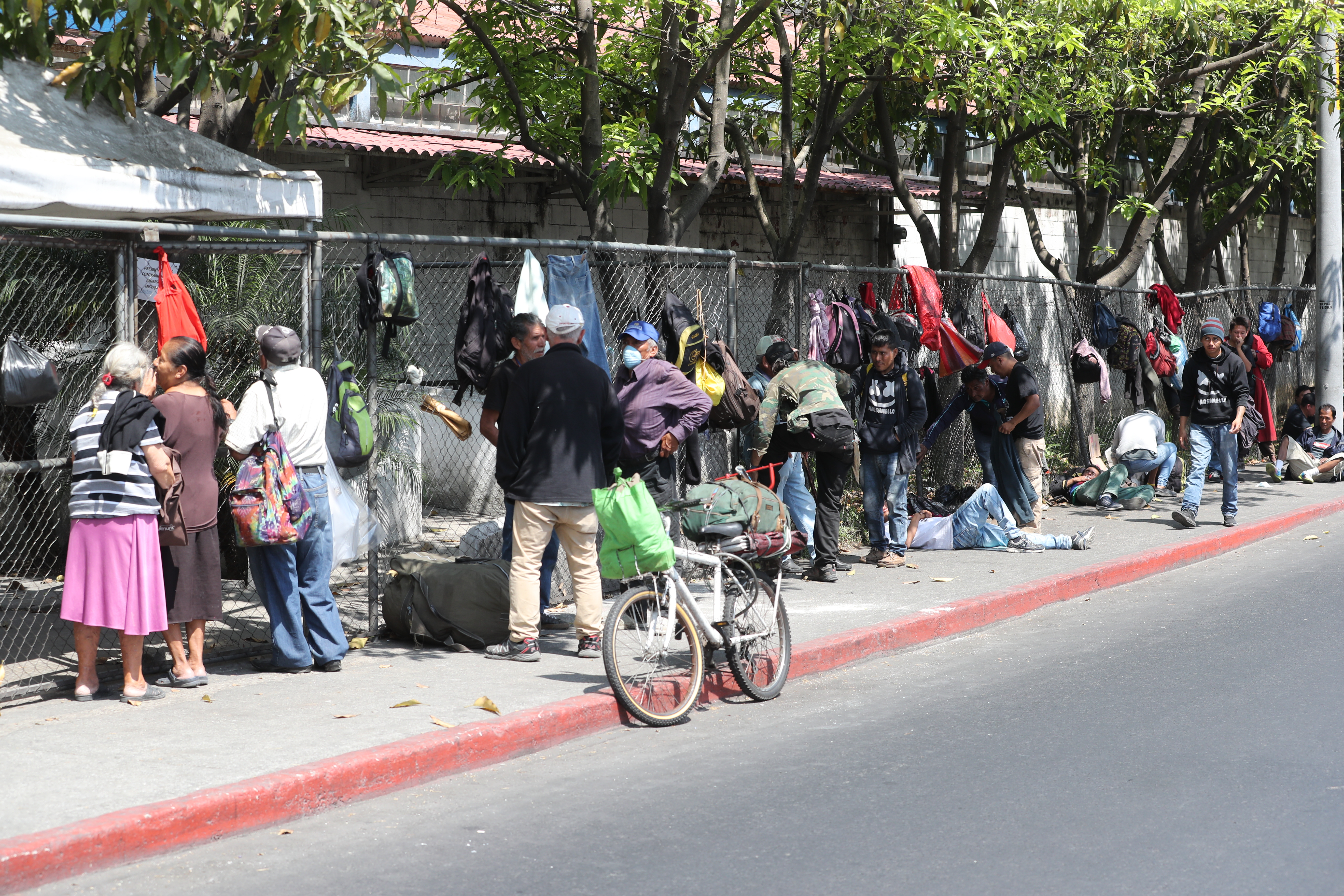 Personas hacen fila en las afueras del comedor social ubicado en la zona 5 a la espera de que lo abran para recibir sus alimentos. (Foto Prensa Libre: Erick Ávila)