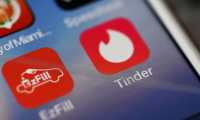 (FILES) In this file photo illustration taken on August 14, 2018, the icon for the dating app Tinder is seen on the screen of an iPhone in Miami, Florida. - Tinder announced on January 23, 2020, that US users would soon have a "panic button" to alert authorities to potentially dangerous situations as part of  a stepped up safety initiative by the popular dating app. A new feature unveiled by Tinder will allow users to opt into the personal safety app Noonlight, which connects users to personal emergency services. (Photo by JOE RAEDLE / GETTY IMAGES NORTH AMERICA / AFP)