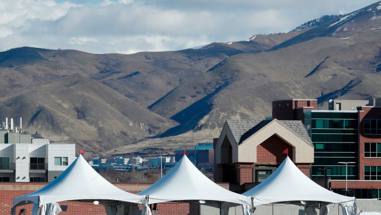 Three tents have been setup for one of the first drive through testing facilities for the Coronavieus (COVID-19) in a parking lot outside the University of Utah's Sugar House Health Clinic  in Salt Lake City, Utah on March 16, 2020. (Photo by GEORGE FREY / AFP)