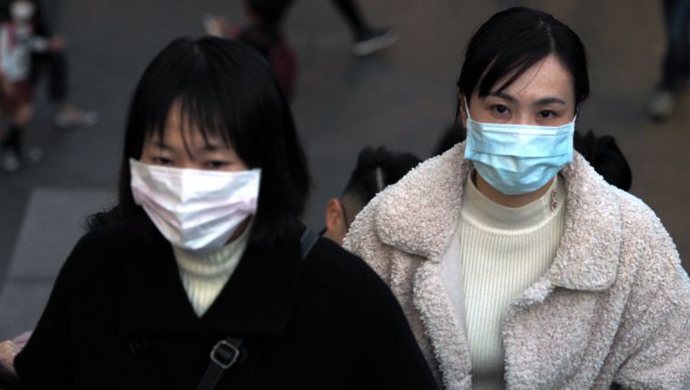 Peatones usan mascarillas desde días recientes en Taiwán a causa del brote de coronavirus en China. (Foto Prensa Libre: EFE)