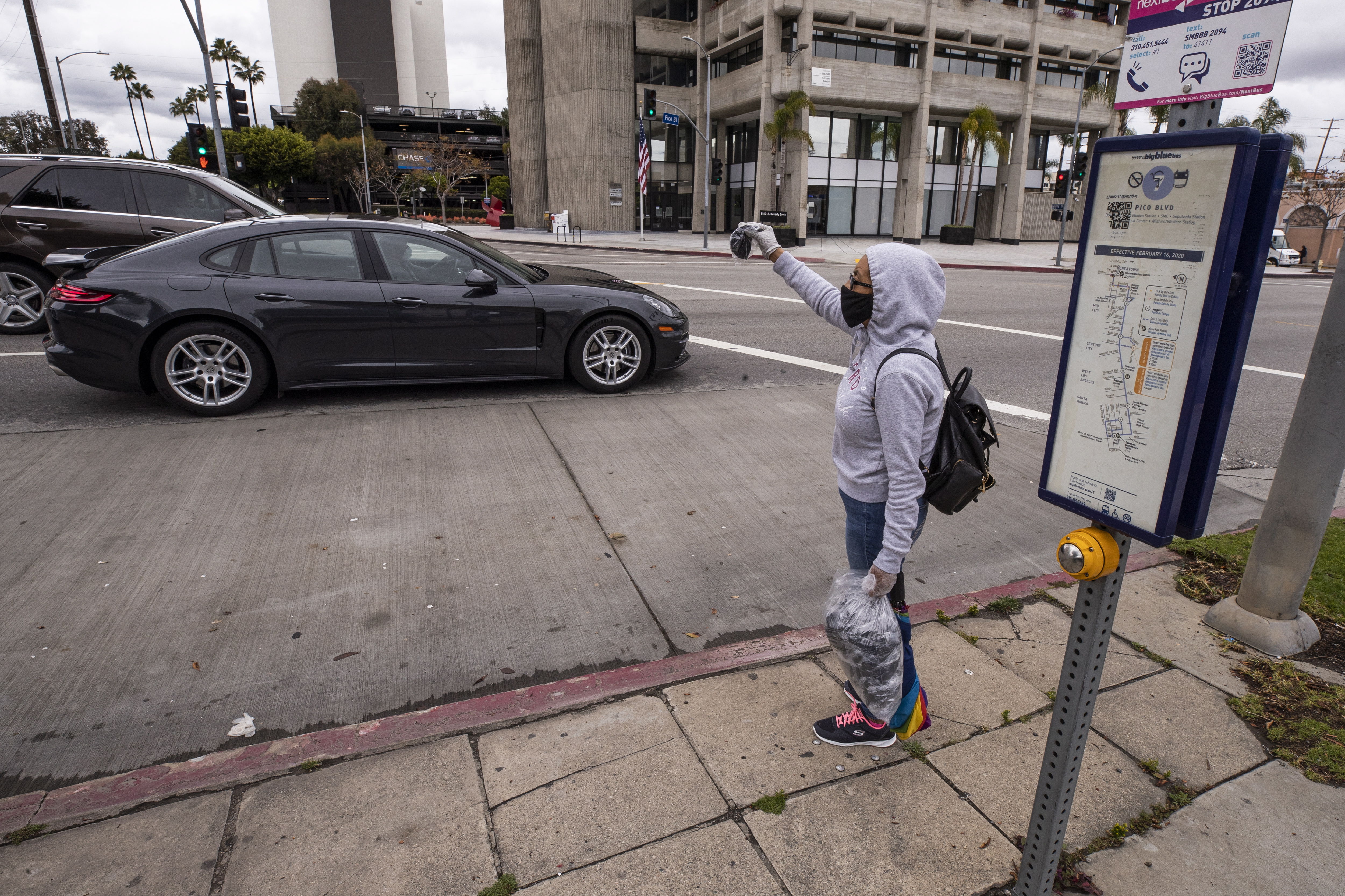María vende máscaras faciales en la esquina de una calle después de perder su trabajo en medio de la pandemia de coronavirus en Los Ángeles, California, EE. UU. (Foto Prensa Libre: EFE).