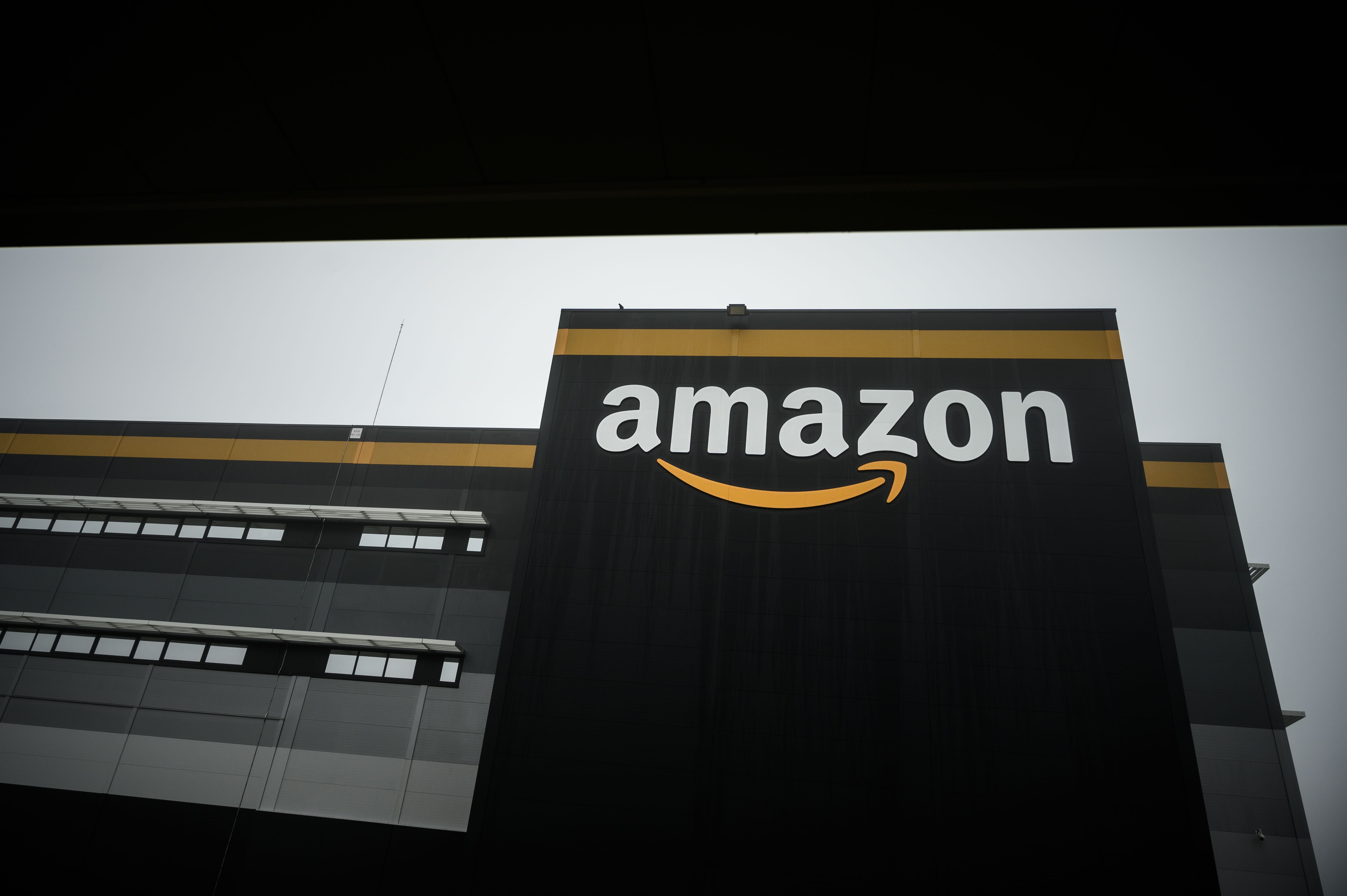 (FILES) This file photo taken on October 22, 2019 shows a new Amazon warehouse, part of mobile robotic fulfilment systems also known as 'Amazon robotics', in Bretigny-sur-Orge, some 30kms south of Paris. - Amazon on April 15, 2020 says may be forced to halt activity at distribution centres after French court decision. The judicial court of Nanterre ordered Amazon France on April 14, 2020, to draw up an assessment of the risks inherent in the Covid-19 epidemic on its warehouses and to restrict its activity in the meantime to essential products only, according to the ruling obtained by AFP. (Photo by Philippe LOPEZ / AFP)