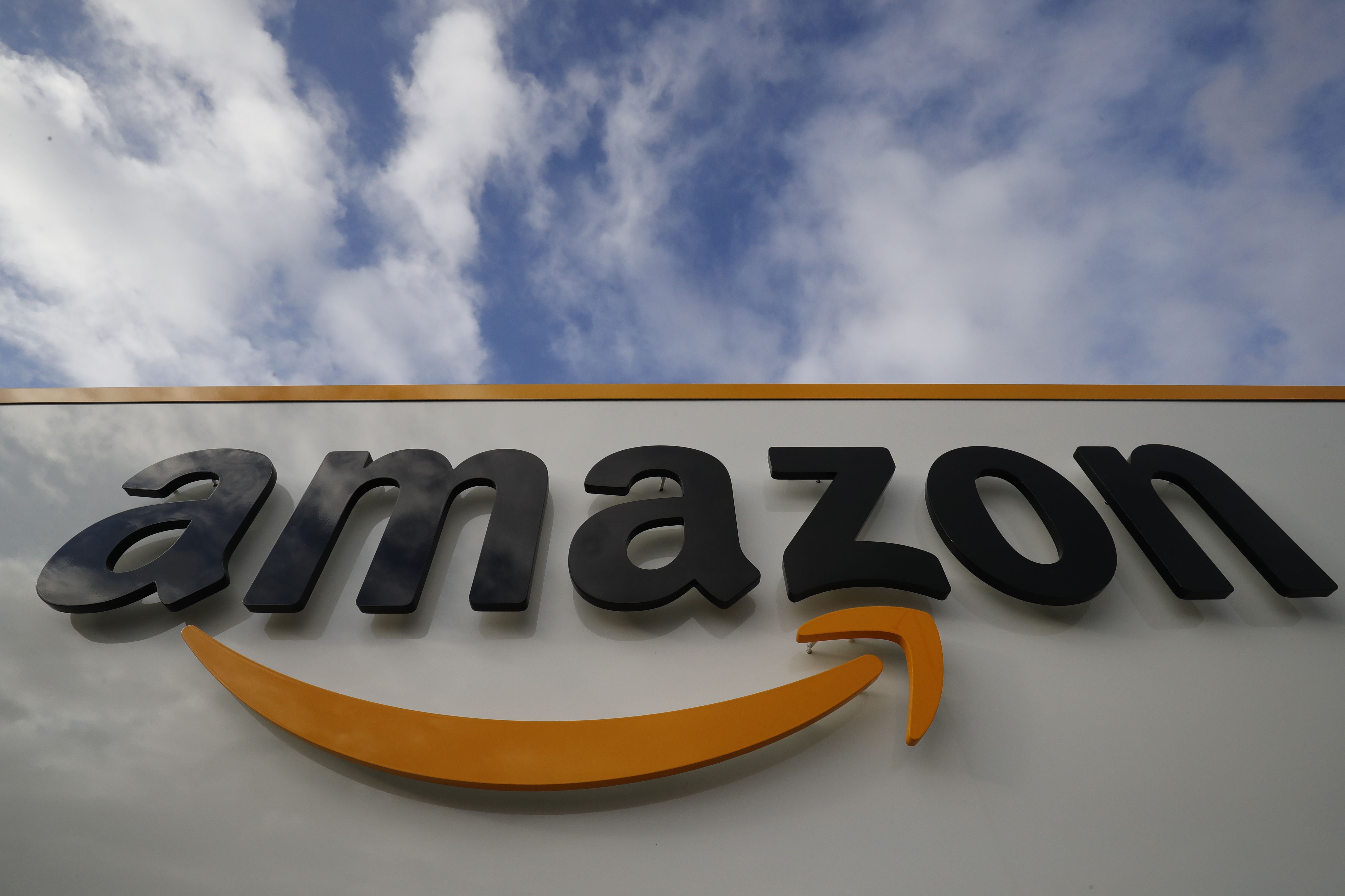 (FILES) This file photograph taken on November 28, 2019, shows a logo on the side of an Amazon company centre in Bretigny-sur-Orge some 25kms south of Paris. - Amazon said on April 15, 2020, that it is closing French sites for five days after court ruling. (Photo by Thomas SAMSON / AFP)