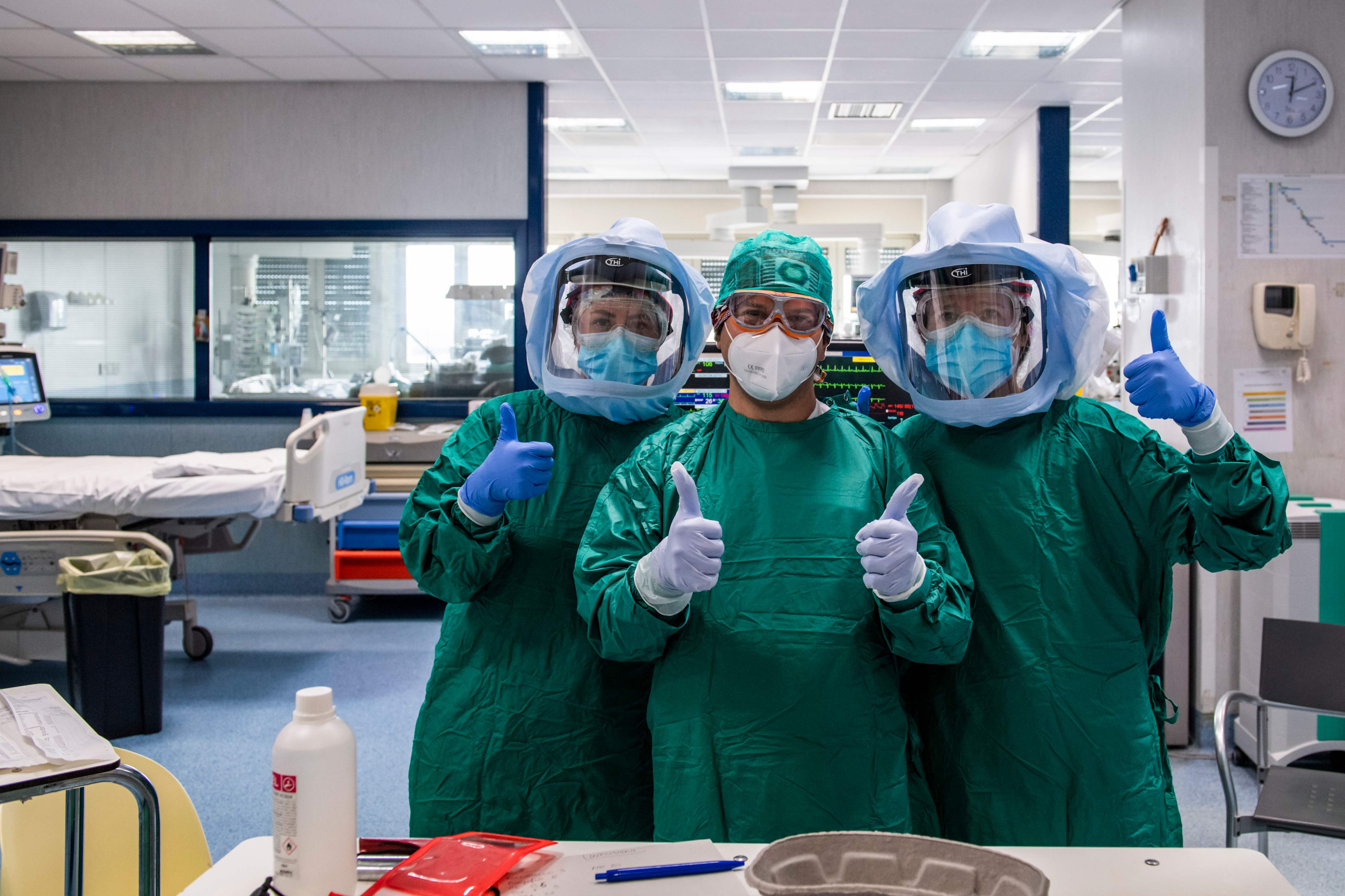 (From L) Italian anesthesiologist Claudia Silvestri, Italian male nurse Maurizio Di Giacobbe and Italian anesthesiologist Giordana Caiacca pose while working at the Intensive Care Unit of the Tor Vergata Covid-4 hospital on April 21, 2020 in Rome, during the country's lockdown aimed at curbing the spread of the COVID-19 infection, caused by the novel coronavirus. (Photo by Andreas SOLARO / AFP)