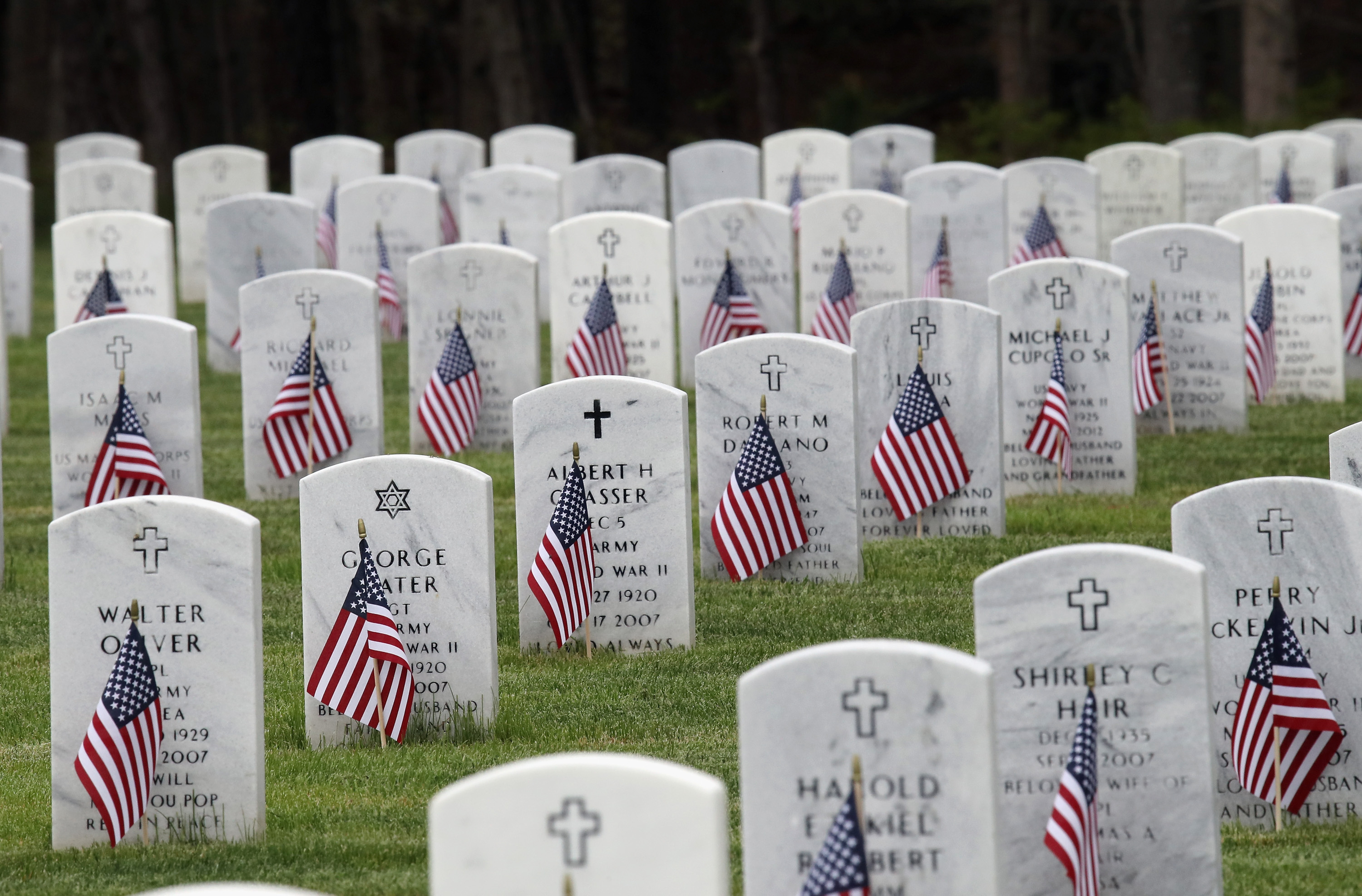 WADING RIVER, NEW YORK - MAY 23: Gravesites are decorated with American flags at Calverton National Cemetery on May 23, 2020 in Wading River, New York. Health guidelines due to the coronavirus pandemic is expected to have a negative effect on those coming to pay their respects to veterans who lost their lives defending the country.   Bruce Bennett/Getty Images/AFP