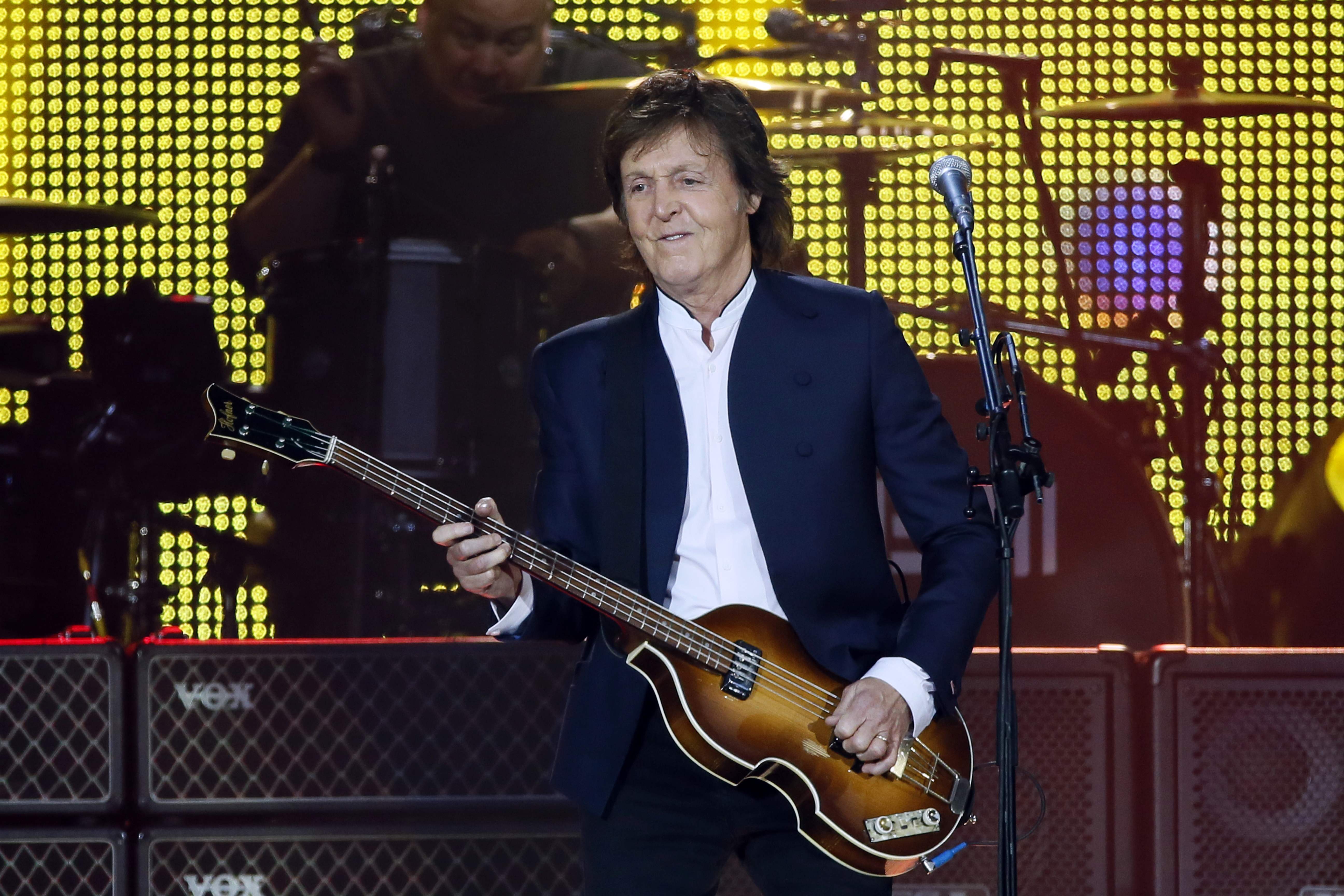 (FILES) In this file photo taken on June 11, 2015 British musician and former Beatles' member Paul McCartney performs  at the Stade de France in Saint-Denis near Paris. - Paul McCartney cancelled his French spring tour on May 7, 2020, due to constraints linked to the COVID-19 (novel coronavirus) pandemic. The former Beatles was due to play on May 23 in Lille, May 26 in Paris (La Defense Arena),  May 31 in Bordeaux and June 7, 2020 in Lyon. (Photo by PATRICK KOVARIK / AFP)