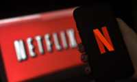 (FILES) In this file illustration photo taken on March 31, 2020 a computer screen and mobile phone display the Netflix logo in Arlington, Virginia. - While coronavirus has brought Hollywood to a halt, Netflix has enjoyed record success. But will the streaming giant's well-stocked slate of future shows be enough to maintain that growth? (Photo by Olivier DOULIERY / AFP)