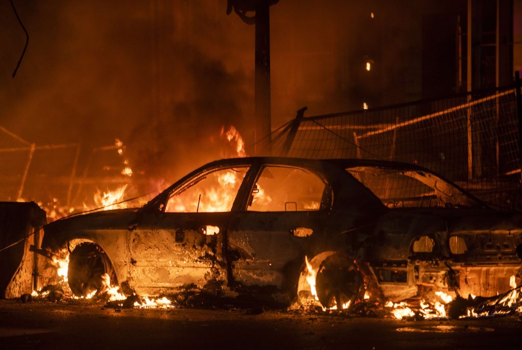 Protestantes incendiaron edificaciones y vehículos en Minneapolis. (Foto Prensa Libre: AFP)