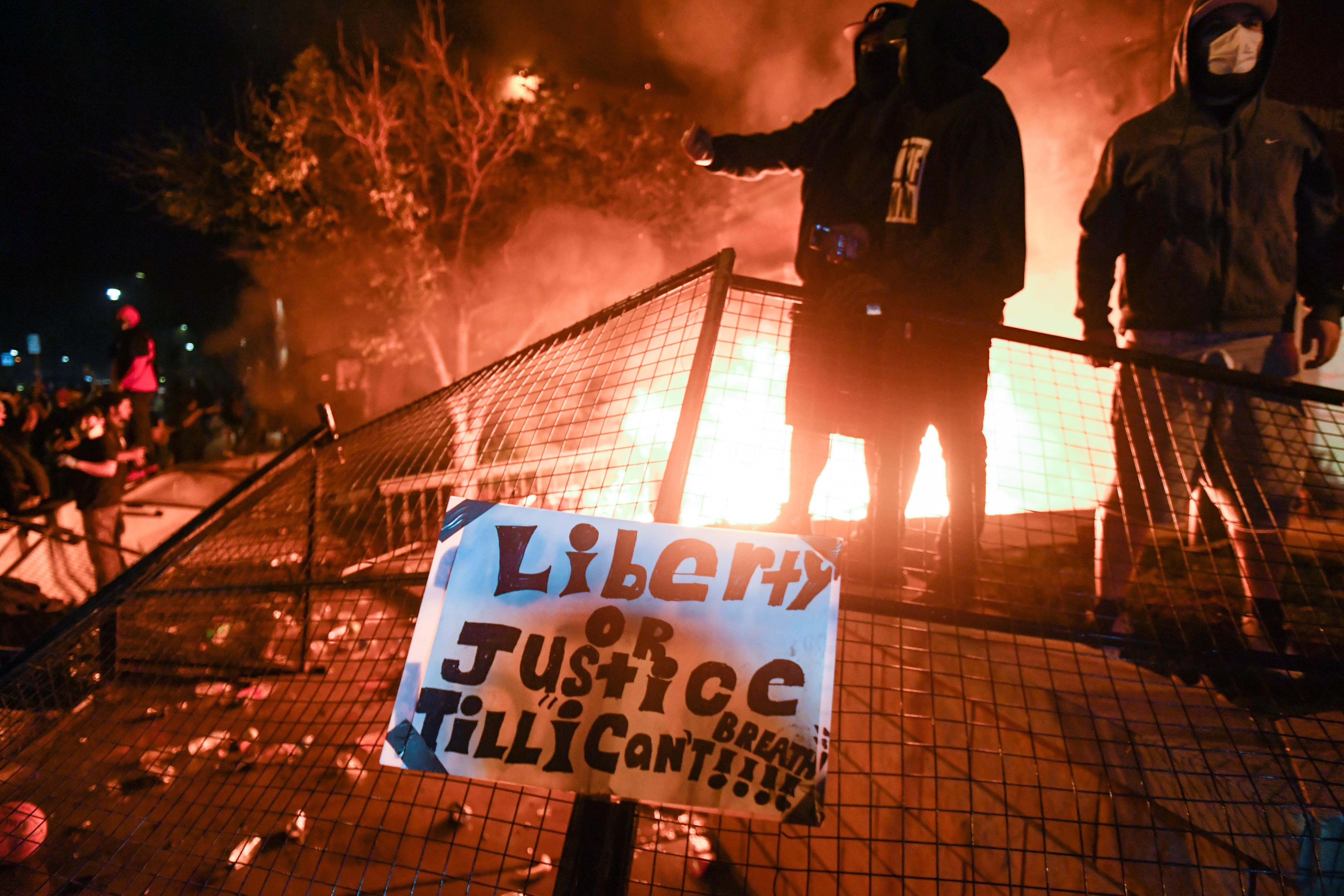 Miles de personas participaron el viernes en la tercera noche consecutiva de protestas en Mineápolis (Minesota) por la muerte a manos de la Policía del afroamericano George Floyd, movilizaciones que derivaron en la quema de una estación de Policía. (Foto Prensa Libre: EFE)