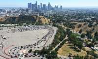 LOS ANGELES, CALIFORNIA - JULY 10: An aerial view of motorists lined up to be tested for COVID-19 in a parking lot at Dodger Stadium amid the coronavirus pandemic on July 10, 2020 in Los Angeles, California. California set a single day record with 9,816 new COVID-19 cases on July 9 amid a surge in hospitalizations and coronavirus related deaths in the state.   Mario Tama/Getty Images/AFP
== FOR NEWSPAPERS, INTERNET, TELCOS & TELEVISION USE ONLY ==