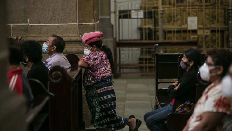 Personas asisten a misa en la Catedral Metropolitana de Guatemala, que reabrió el templo con ciertas medidas sanitarias para recibir feligreses. (Foto Prensa Libre: EFE)