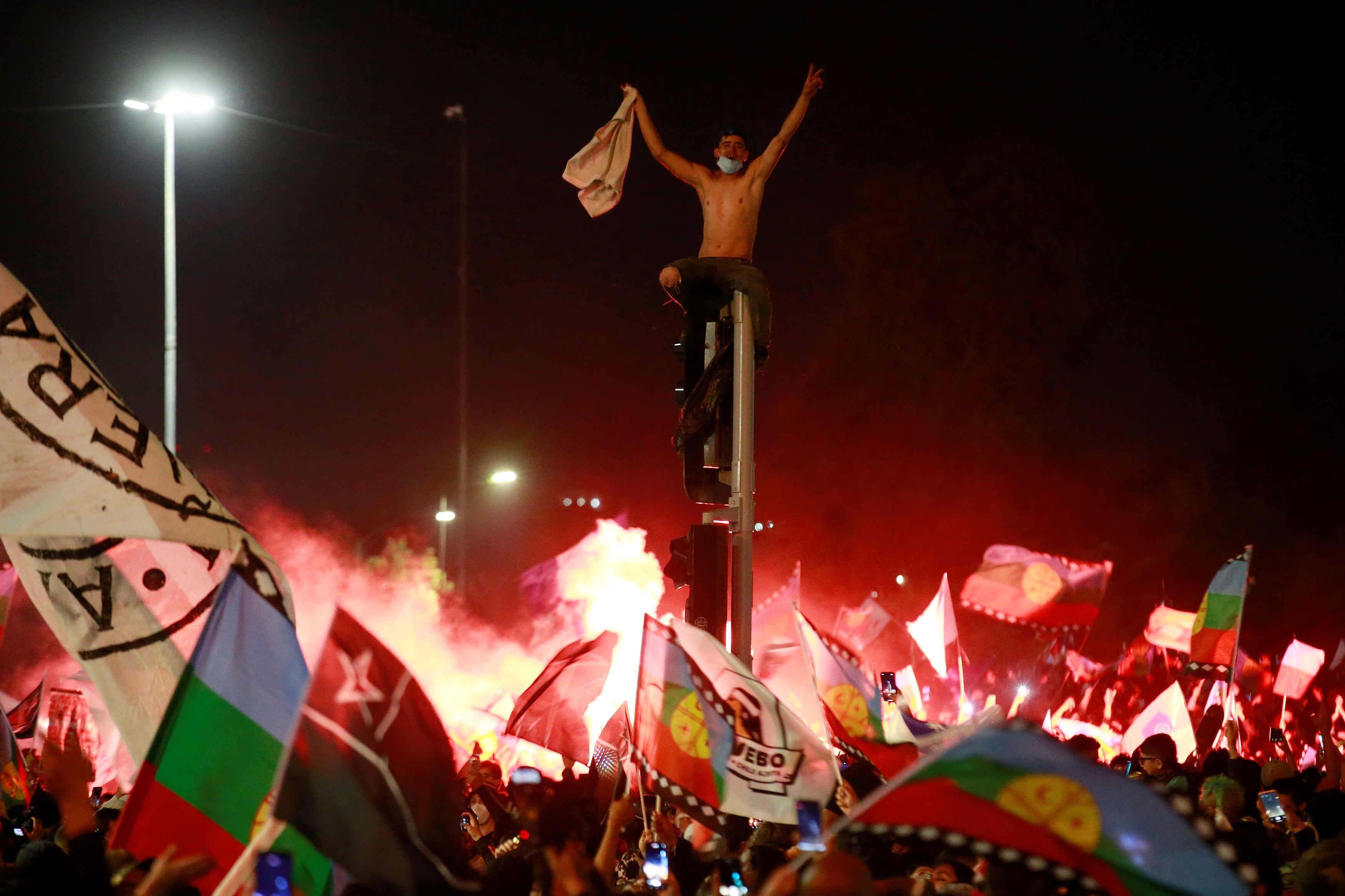 Decenas de personas celebran luego de conocer los resultados parciales del plebiscito constitucional, que apuntan al triunfo por una nueva Carta Magna hoy, en Santiago (Chile). (Foto Prensa Libre: EFE)