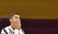 (FILES) In this file photo taken on September 27, 2020 Juventus' Portuguese forward Cristiano Ronaldo reacts after missing a goal opportunity during the Italian Serie A football match Roma vs Juventus on September 27, 2020 at the Olympic stadium in Rome. - Cristiano Ronaldo has tested positive for Covid-19, the Portuguese Football Federation announced on October 13, 2020. (Photo by Tiziana FABI / AFP)