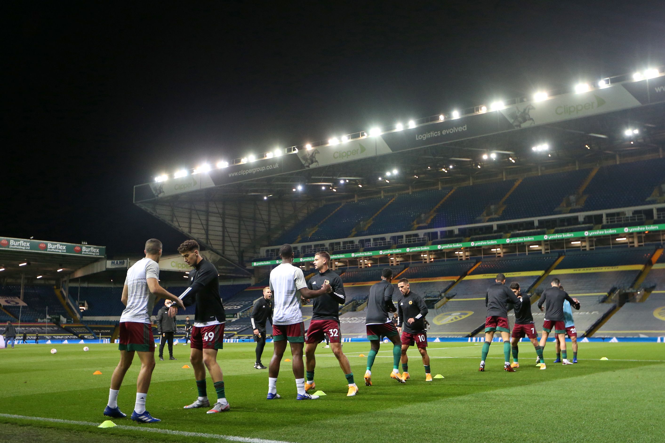 Wolves' players warm up ahead of the English Premier League football match between Leeds United and Wolverhampton Wanderers at Elland Road in Leeds, northern England on October 19, 2020. (Photo by Alex Pantling / POOL / AFP) / RESTRICTED TO EDITORIAL USE. No use with unauthorized audio, video, data, fixture lists, club/league logos or 'live' services. Online in-match use limited to 120 images. An additional 40 images may be used in extra time. No video emulation. Social media in-match use limited to 120 images. An additional 40 images may be used in extra time. No use in betting publications, games or single club/league/player publications. /