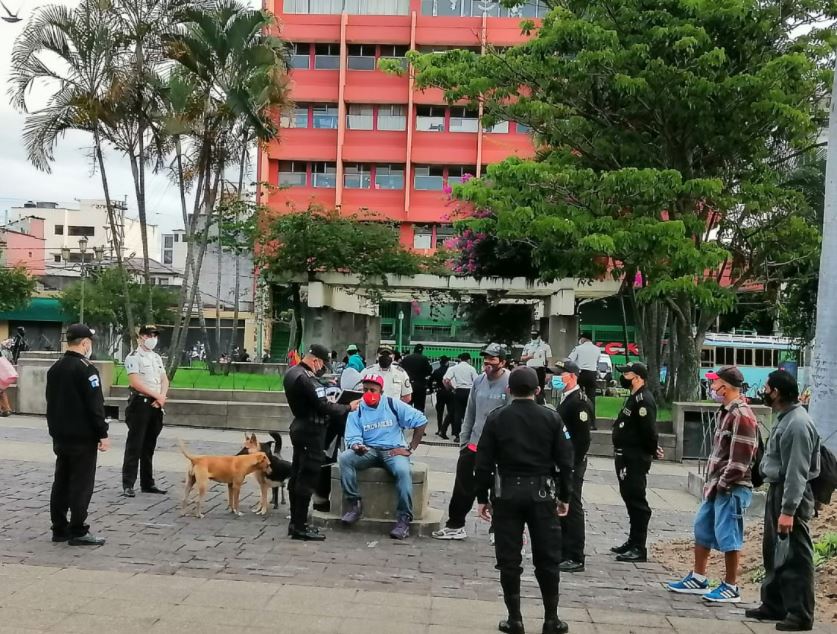 Agentes policiales piden documentos a jóvenes en el Parque Centenario, zona 1, con la sospecha de que son migrantes centroamericanos. (Foto: IGM)