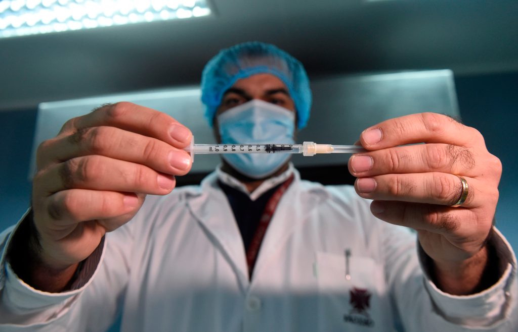 Un doctor muestra una dosis de la vacuna contra el coronavirus. (Foto Prensa Libre: AFP)