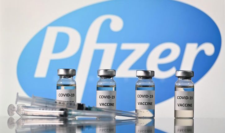 An illustration picture shows vials with Covid-19 Vaccine stickers attached and syringes with the logo of US pharmaceutical company Pfizer, on November 17, 2020. (Photo by JUSTIN TALLIS / AFP)
