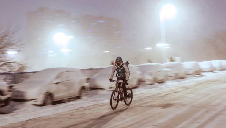 Un repartidor en bicicleta circula por la madrileña avenida Ramón y Cajal completamente nevada, en una jornada en la que la Agencia Estatal de Meteorología ha activado el nivel rojo por la previsión de fuertes nevadas. (Foto Prensa Libre: EFE) 	