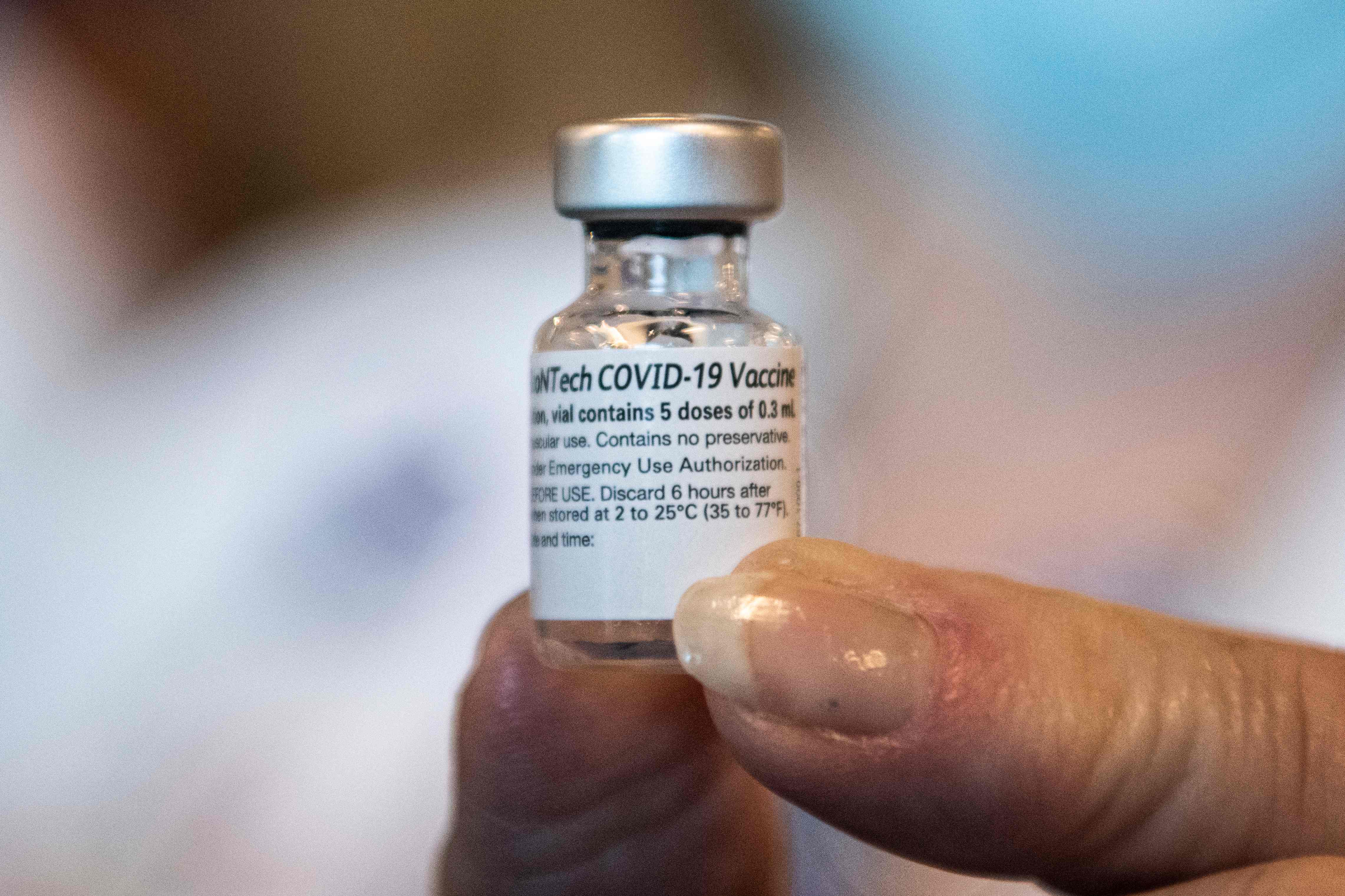 (FILES) In this file photo taken on December 14, 2020, a healthcare worker holds a Pfizer-BioNtech Covid-19 vaccine at Memorial Healthcare System, in Miramar, Florida. - Pfizer and BioNTech said on February 25, 2021, they are studying adding a third dose to their vaccine regime and testing a new version targeting the South African variant of the coronavirus. In one study, the US and German pharmaceutical firms said they would look at what happens when people are given a third dose of their two-shot vaccine, six to 12 months after the booster. (Photo by CHANDAN KHANNA / AFP)