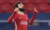 Liverpool's Egyptian midfielder Mohamed Salah celebrates scoring his team's first goal during the UEFA Champions league Last 16 2nd Leg football match between Liverpool and RB Leipzig at Puskas Arena in Budapest, Hungary, on March 10, 2021. (Photo by Attila KISBENEDEK / AFP)