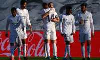 Real Madrid's French forward Karim Benzema (C back) celebrates with teammates after scoring a goal during the Spanish League football match between Real Madrid and Elche at the Alfredo Di Stefano stadium in Valdebebas, northeast of Madrid, on March 13, 2021. (Photo by GABRIEL BOUYS / AFP)