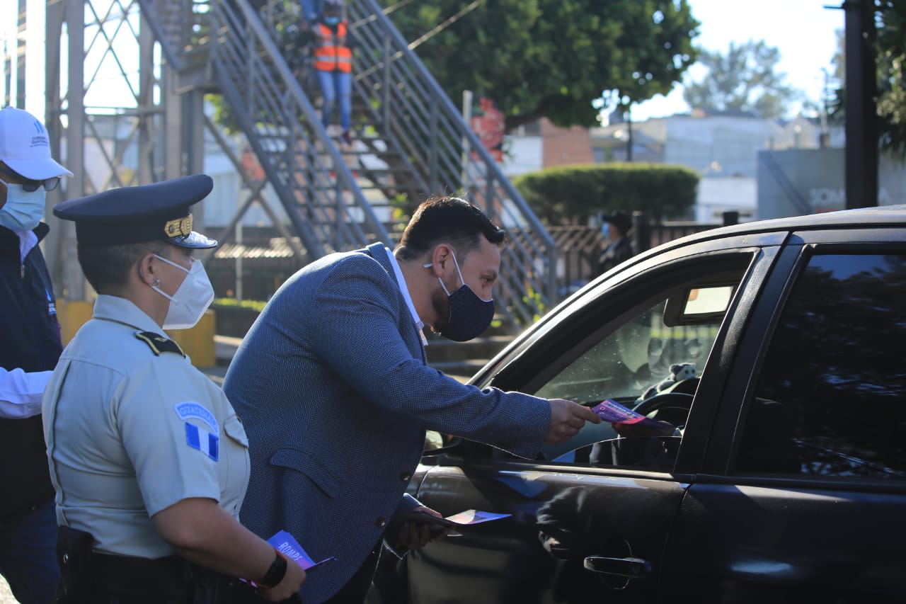 El ministro de Gobernación Gendri Reyes reparte trifoliares con motivo Día Internacional de la Mujer. (Foto Prensa Libre: PNC)  