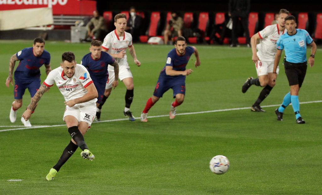 SEVILLA 04/04/2021.- Lucas Ocampos, del Sevilla, lanza el penalti contra el Atlético de Madrid, que desviaría el esloveno del Atletico de Madrid Jan Oblak, durante el partido de la jornada 29 de LaLiga Santander que se disputa en el estadio Sánchez Pizjuán. EFE/Julio Muñoz