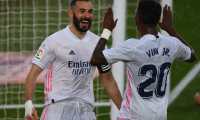 Real Madrid's French forward Karim Benzema (L) celebrates with Real Madrid's Brazilian forward Vinicius Junior after scoring a goal during the Spanish League football match between Real Madrid CF and SD Eibar at the Alfredo di Stefano stadium in Valdebebas on the outskirts of Madrid on April 3, 2021. (Photo by GABRIEL BOUYS / AFP)