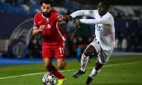 Real Madrid's French defender Ferland Mendy (R) challenges Liverpool's Egyptian midfielder Mohamed Salah during the UEFA Champions League first leg quarter-final football match between Real Madrid and Liverpool at the Alfredo di Stefano stadium in Valdebebas in the outskirts of Madrid on April 6, 2021. (Photo by GABRIEL BOUYS / AFP)