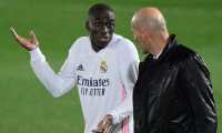 Real Madrid's French defender Ferland Mendy (L) talks to Real Madrid's French coach Zinedine Zidane during the "El Clasico" Spanish League football match between Real Madrid CF and FC Barcelona at the Alfredo di Stefano stadium in Valdebebas, on the outskirts of Madrid on April 10, 2021. (Photo by JAVIER SORIANO / AFP)