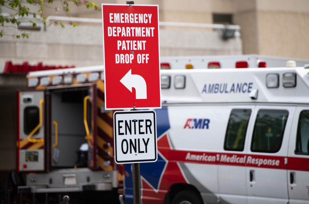 Ambulances sit outside the emergency room at Washington Hospital Center during the COVID-19, known as coronavirus, pandemic in Washington, DC, April 7, 2020. (Photo by SAUL LOEB / AFP)