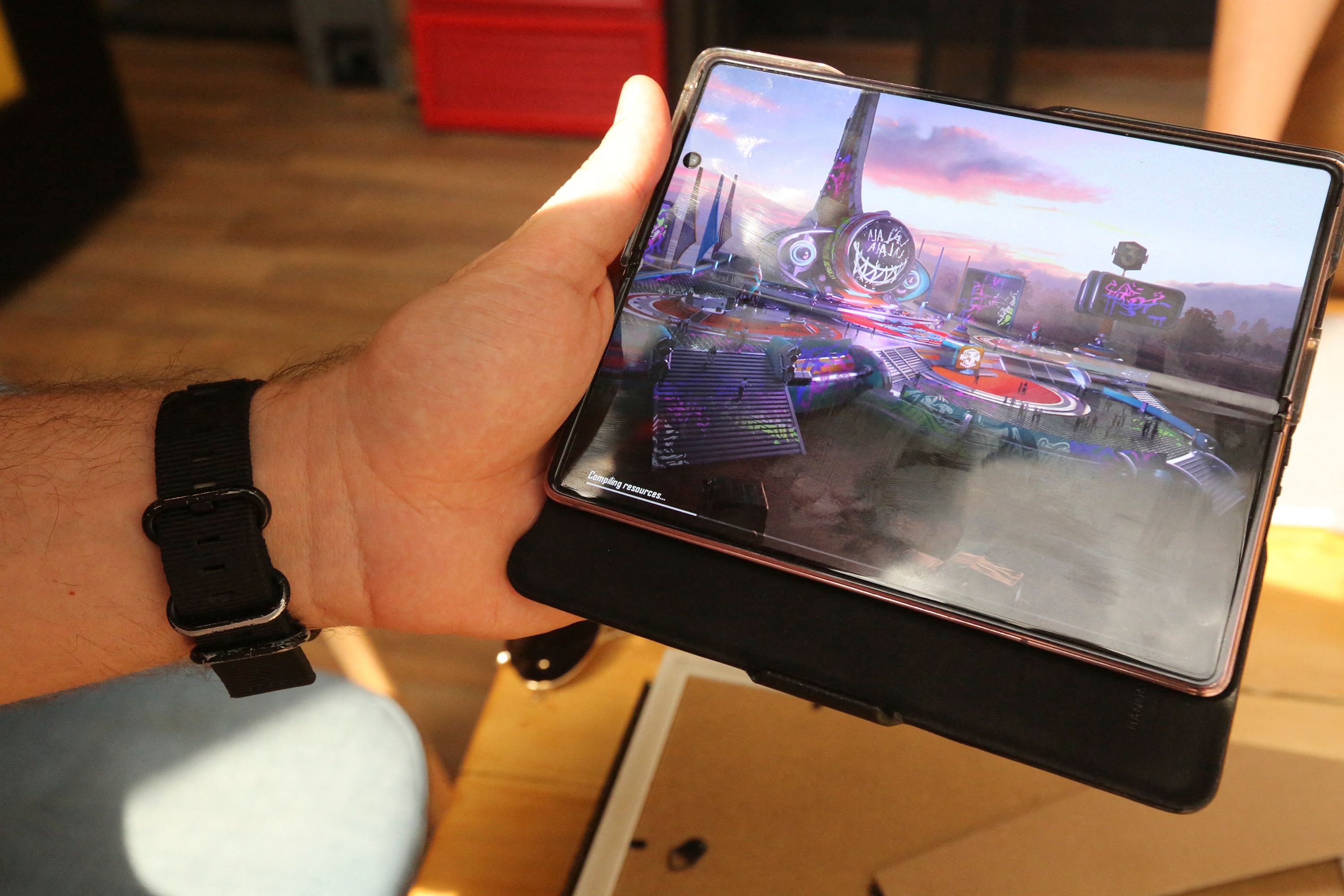 President of the Iraqi eSports Federation Hayder Jaafar plays on a mobile device during an interview in the capital Baghdad on May 4, 2021. - The mobile version of the PlayerUnknown's Battlegrounds game has become so popular in Iraq that the country's youth have been dubbed the 