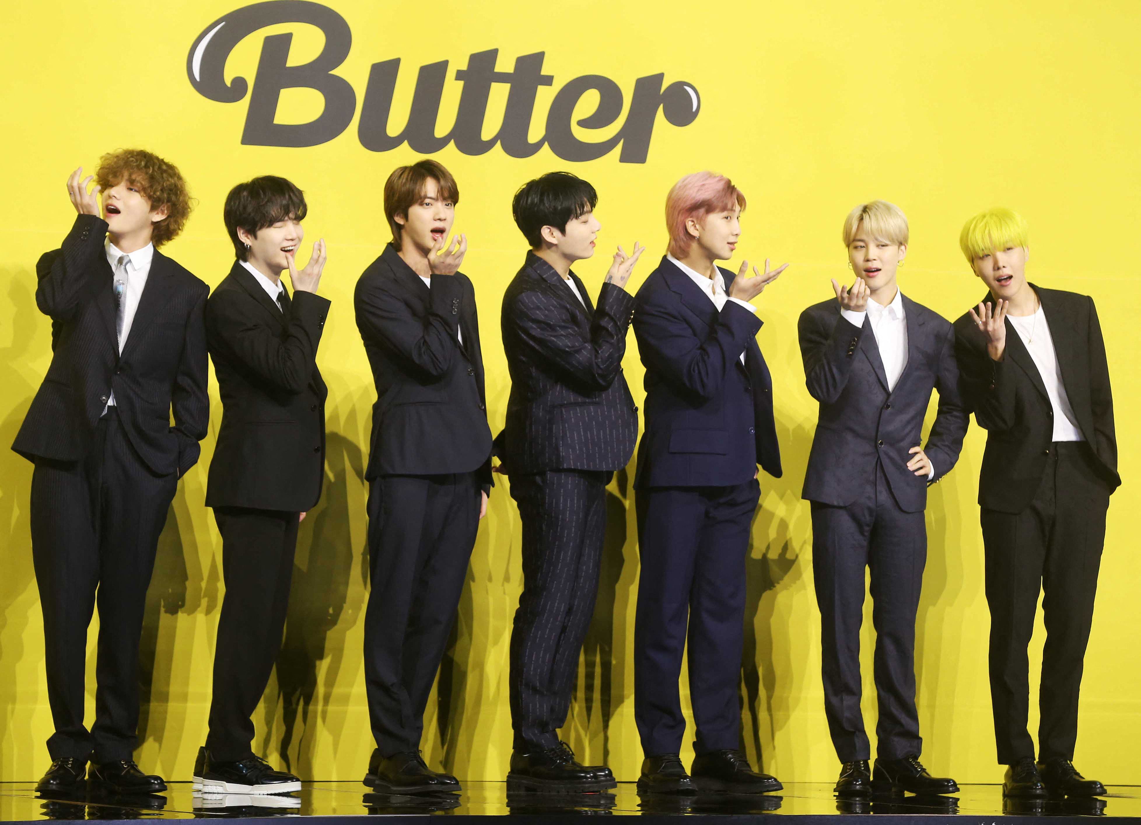 Members of South Korean K-pop boy band BTS pose for photographs during a press conference to promote their new single album 'Butter' in Seoul on May 21, 2021. (Photo by - / Dong-A Ilbo / AFP) / South Korea OUT