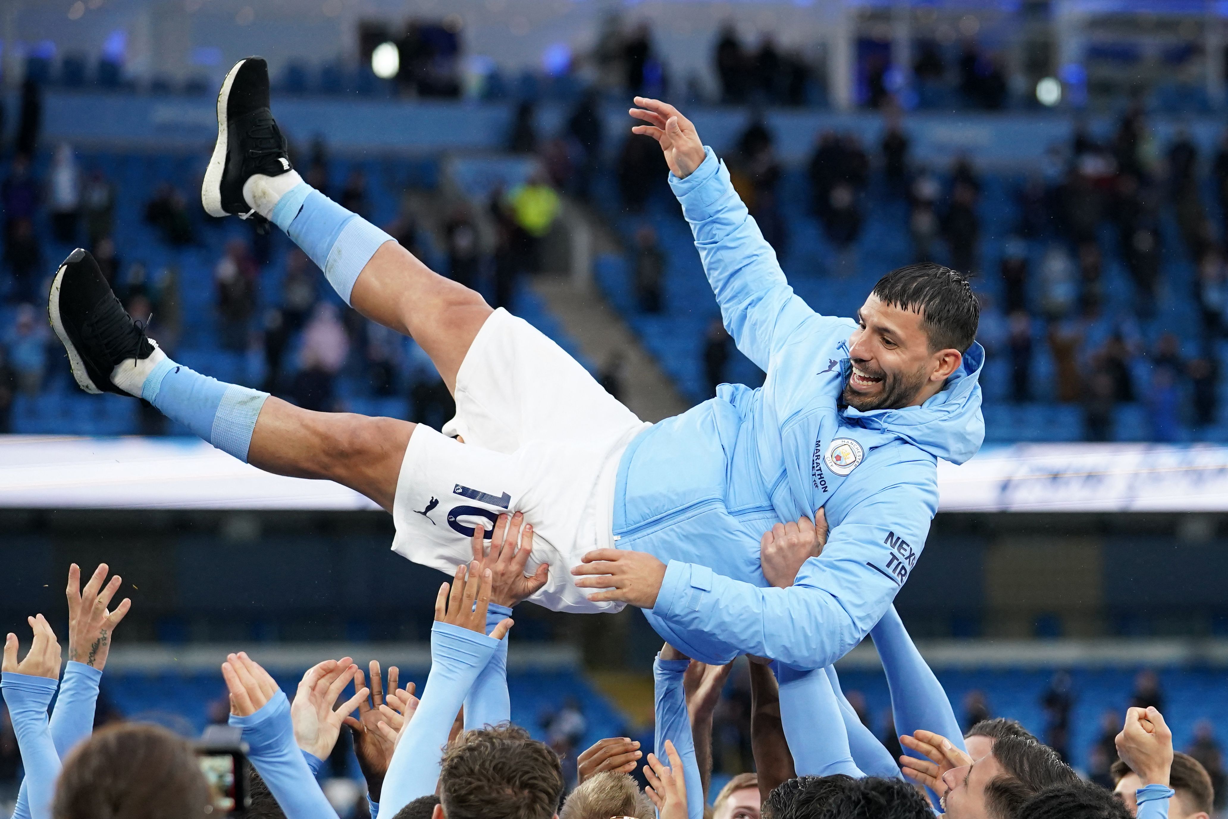 Players lifter Manchester City's Argentinian striker Sergio Aguero aloft during the trophy award ceremony after the English Premier League football match between Manchester City and Everton at the Etihad Stadium in Manchester, north west England, on May 23, 2021. (Photo by Dave Thompson / POOL / AFP) / RESTRICTED TO EDITORIAL USE. No use with unauthorized audio, video, data, fixture lists, club/league logos or 'live' services. Online in-match use limited to 120 images. An additional 40 images may be used in extra time. No video emulation. Social media in-match use limited to 120 images. An additional 40 images may be used in extra time. No use in betting publications, games or single club/league/player publications. /