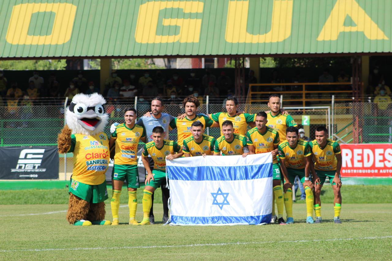 El equipo de Guastatoya muestra la bandera de Israel antes de iniciar el partido contra Santa Lucía. (Foto Redes).