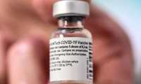 (FILES) This file photo taken on January 6, 2021, shows a vial of the Pfizer-BioNTech Covid-19 vaccine at the AP-HP Vaugirard hospital, in Paris. - The EU has concluded a deal with BioNTech/Pfizer for up to 1.8 billion extra doses of its Covid-19 vaccine, European Commission chief Ursula von der Leyen said on May 8, 2021. (Photo by BERTRAND GUAY / AFP)