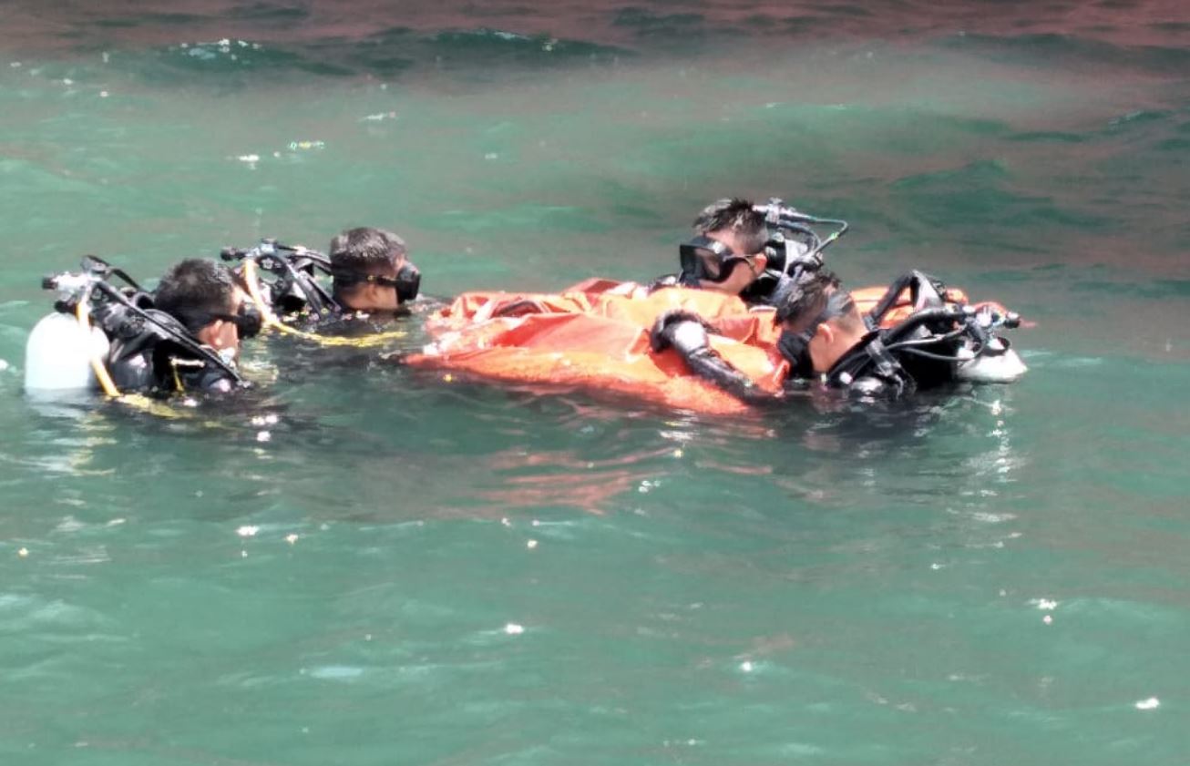 Buzos de la Marina del Ejército de Guatemala, recuperan las tres maletas que fueron localizadas bajo el barco que atracó en Puerto Quetzal, Escuintla. (Foto Prensa Libre: Ejército de Guatemala)