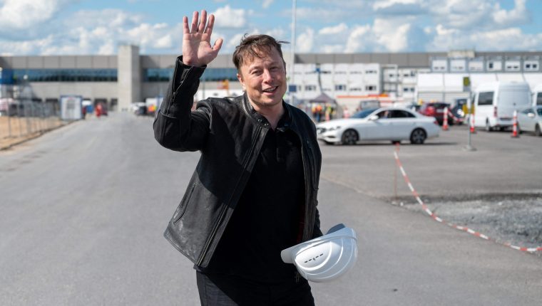 Tesla CEO Elon Musk poses for a photo with a hard hat at the construction site for the new plant, the so-called 