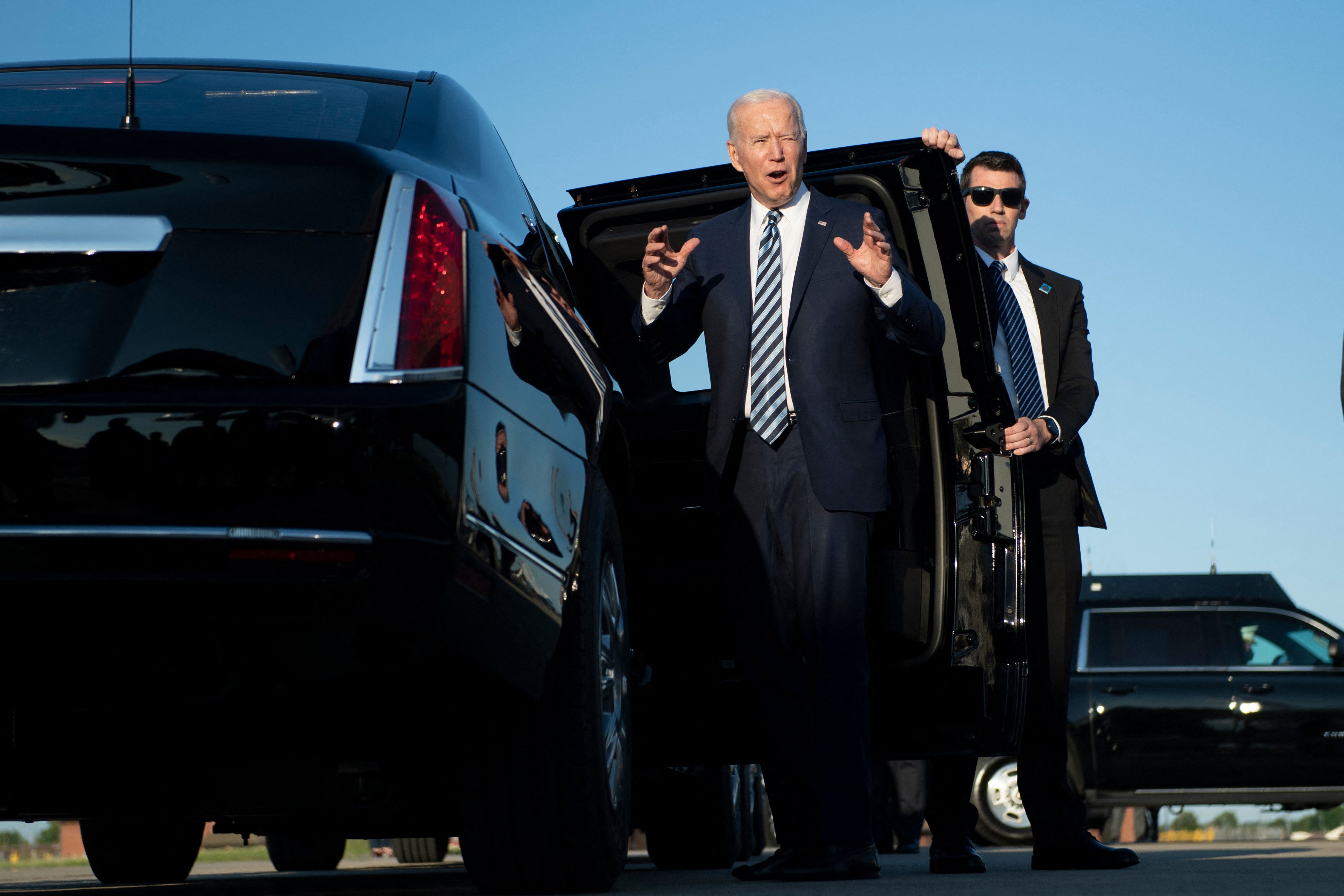 US President Joe Biden shouts to media personel on his arrival at Royal Air Force Mildenhall, Suffolk, England on June 9, 2021, ahead of the three-day G7 Summit. - G7 leaders from Canada, France, Germany, Italy, Japan, the UK and the United States meet this weekend for the first time in nearly two years, for the three-day talks in Carbis Bay, Cornwall. (Photo by Brendan Smialowski / AFP)