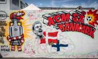 A mural with a portrait of Christian Eriksen reads 'Come on, Denmark' on the wall of the Football Village at Ofelia Beach in Copenhagen, Denmark on June 14, 2021, two days after Danish footballer Christian Eriksen collapsed during the Euro 2021 match between Denmark and Finland. (Photo by Mads Claus Rasmussen / Ritzau Scanpix / AFP) / Denmark OUT